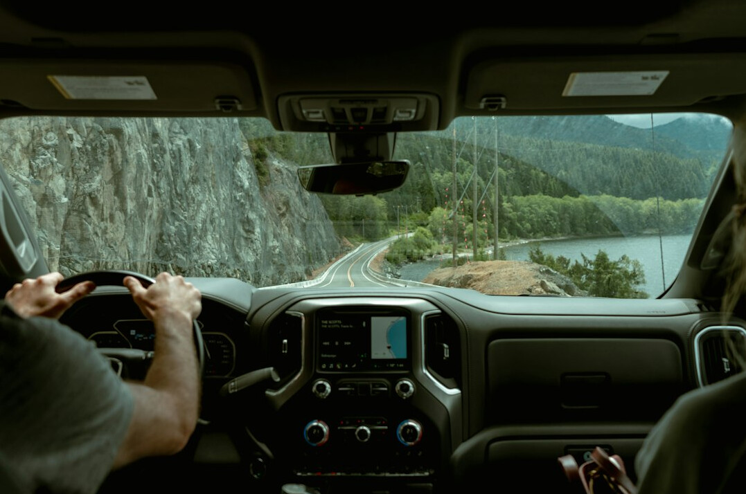 person driving car on scenic road