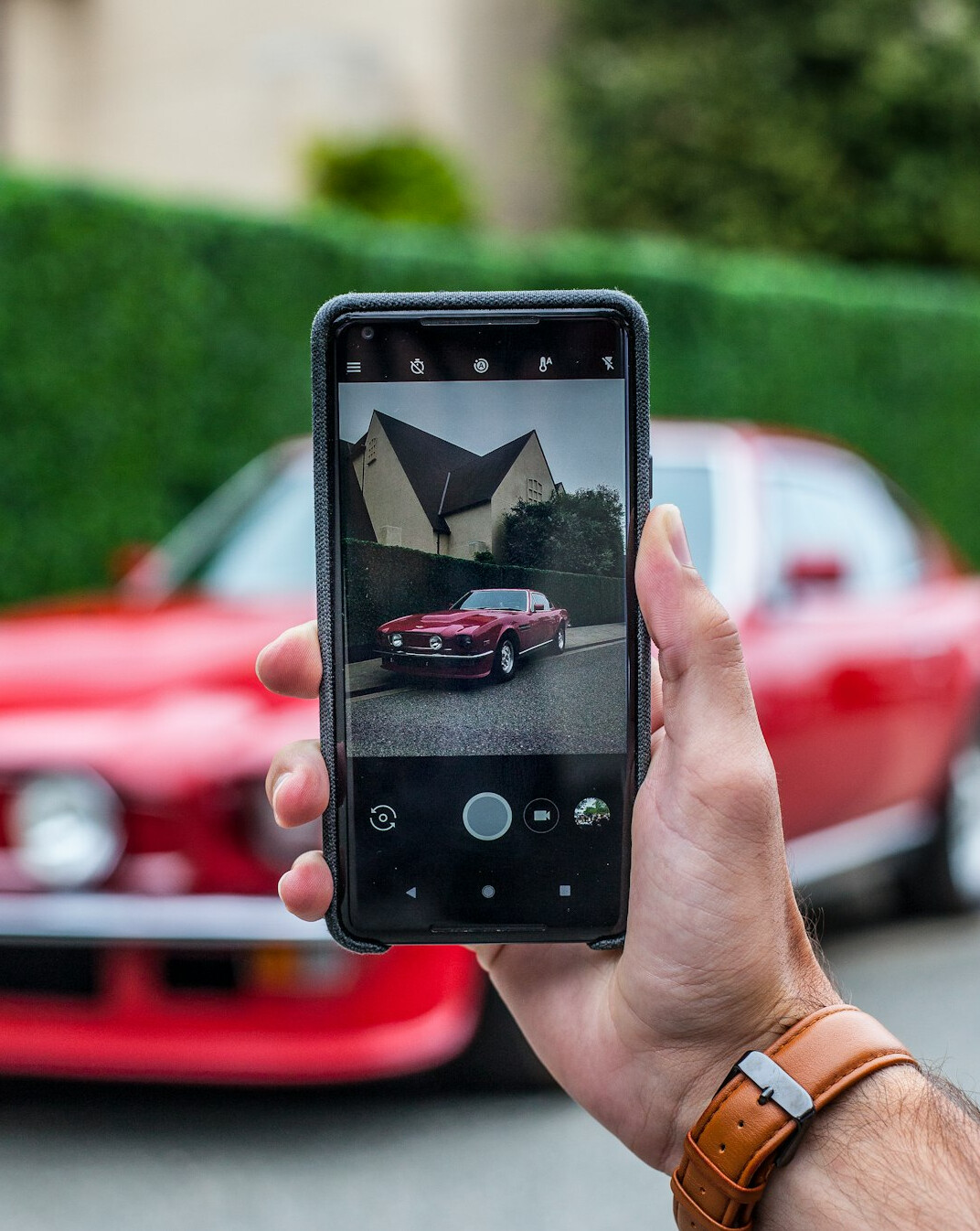 Photographer capturing a classic automobile for an editorial feature