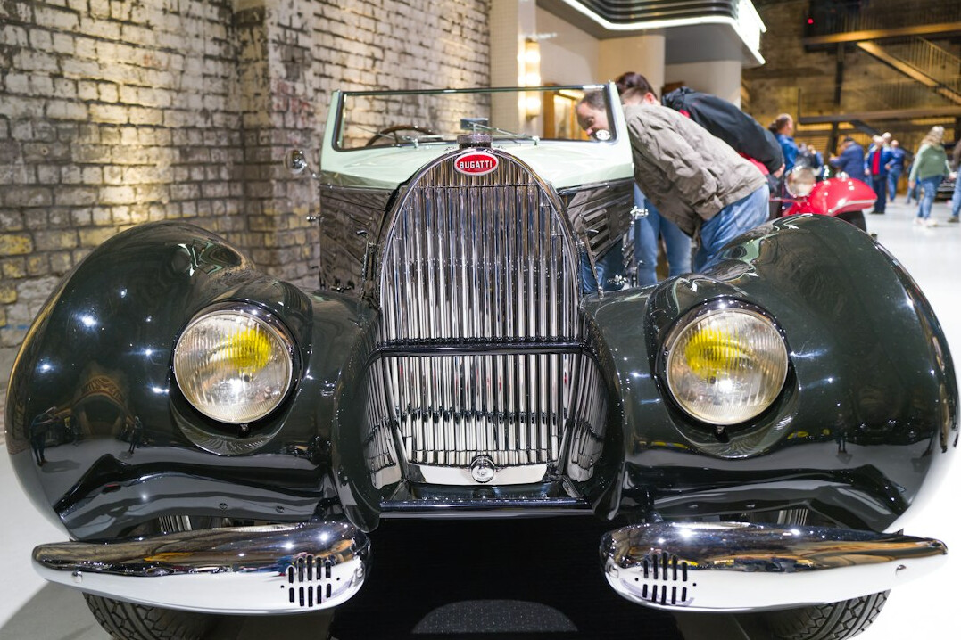 Rare vintage Bugatti automobile displayed indoors before an auction event