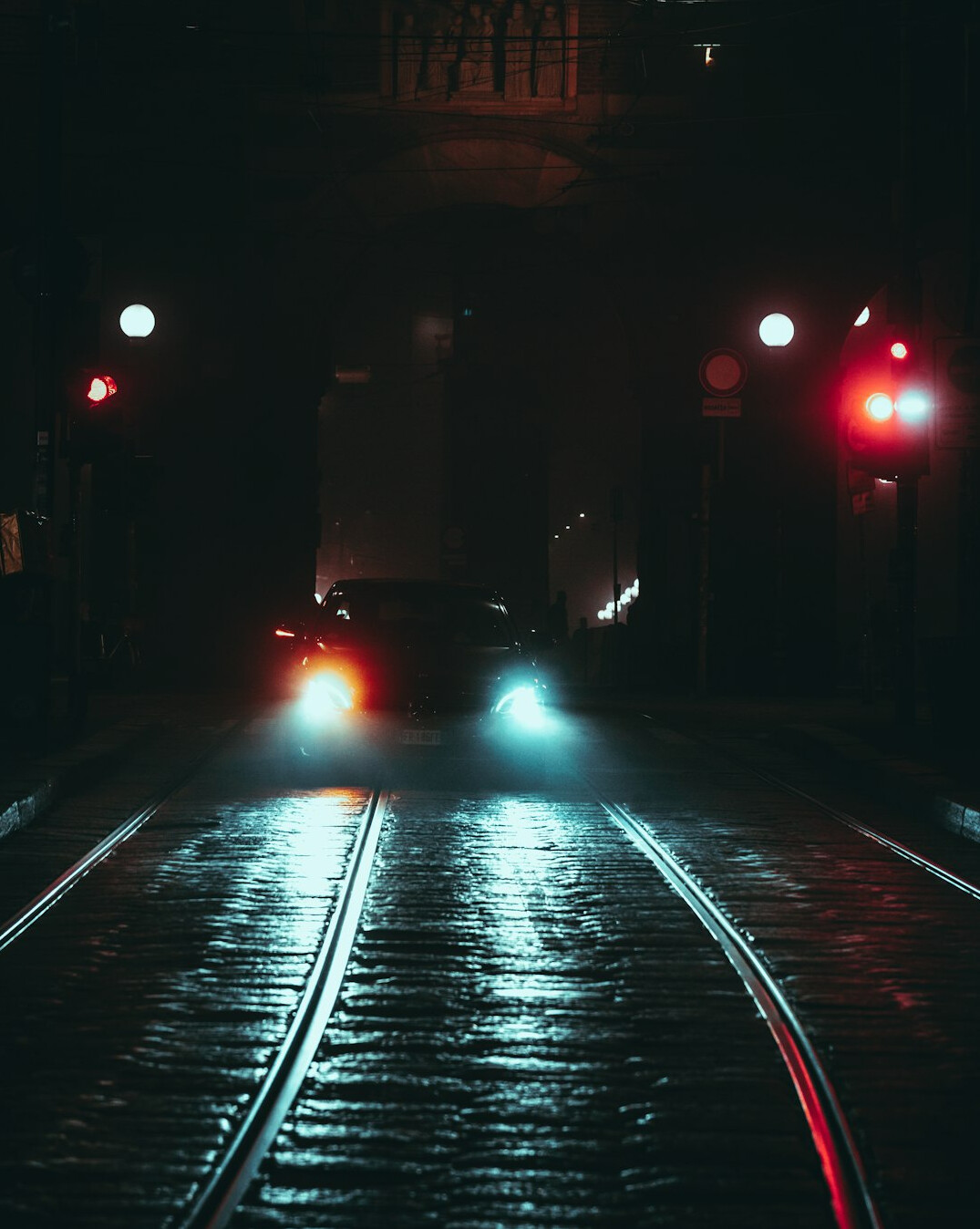 Exotic supercar photographed from a low angle at night with city lights in background