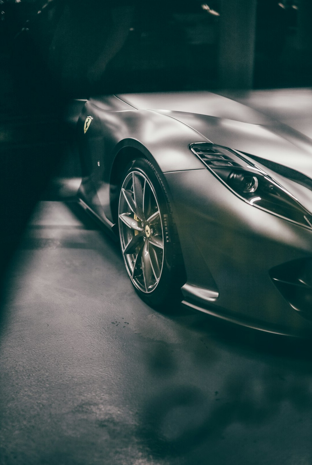 Modern hypercar with aggressive aerodynamic bodywork photographed in low light